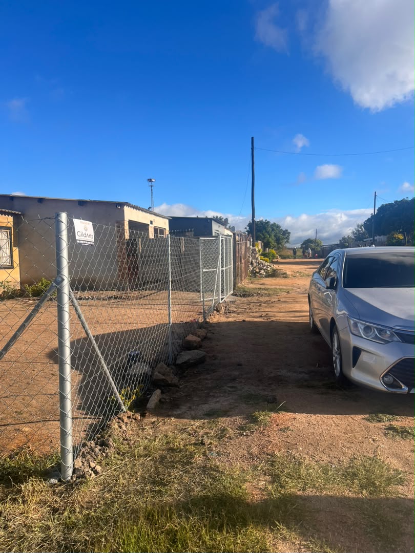 Chain-link perimeter fence with gate installed by GildArts