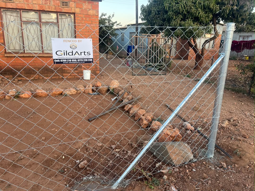 Residential yard chain-link fence with GildArts branding
