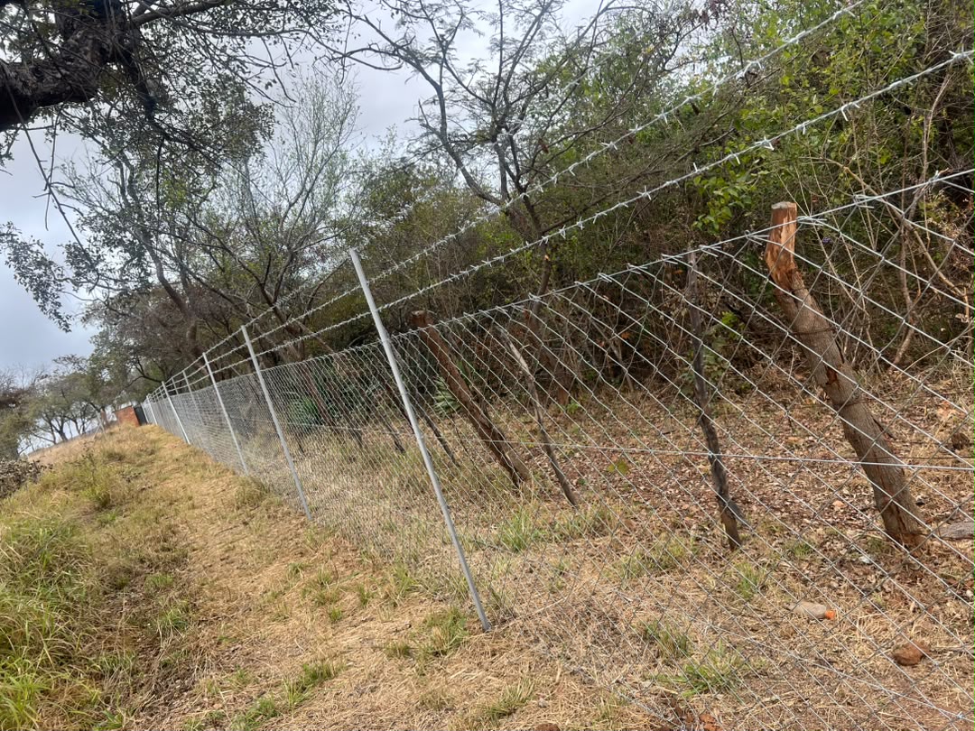 Bush perimeter diamond mesh and barbed wire fence installed by GildArts